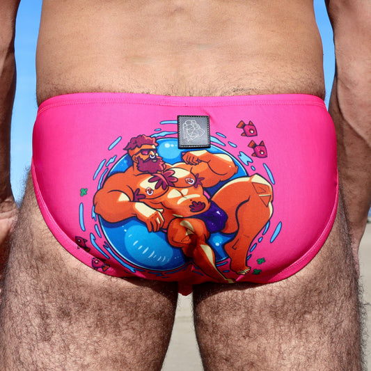 Pink swim brief with cartoon design on a person against a blue sky.