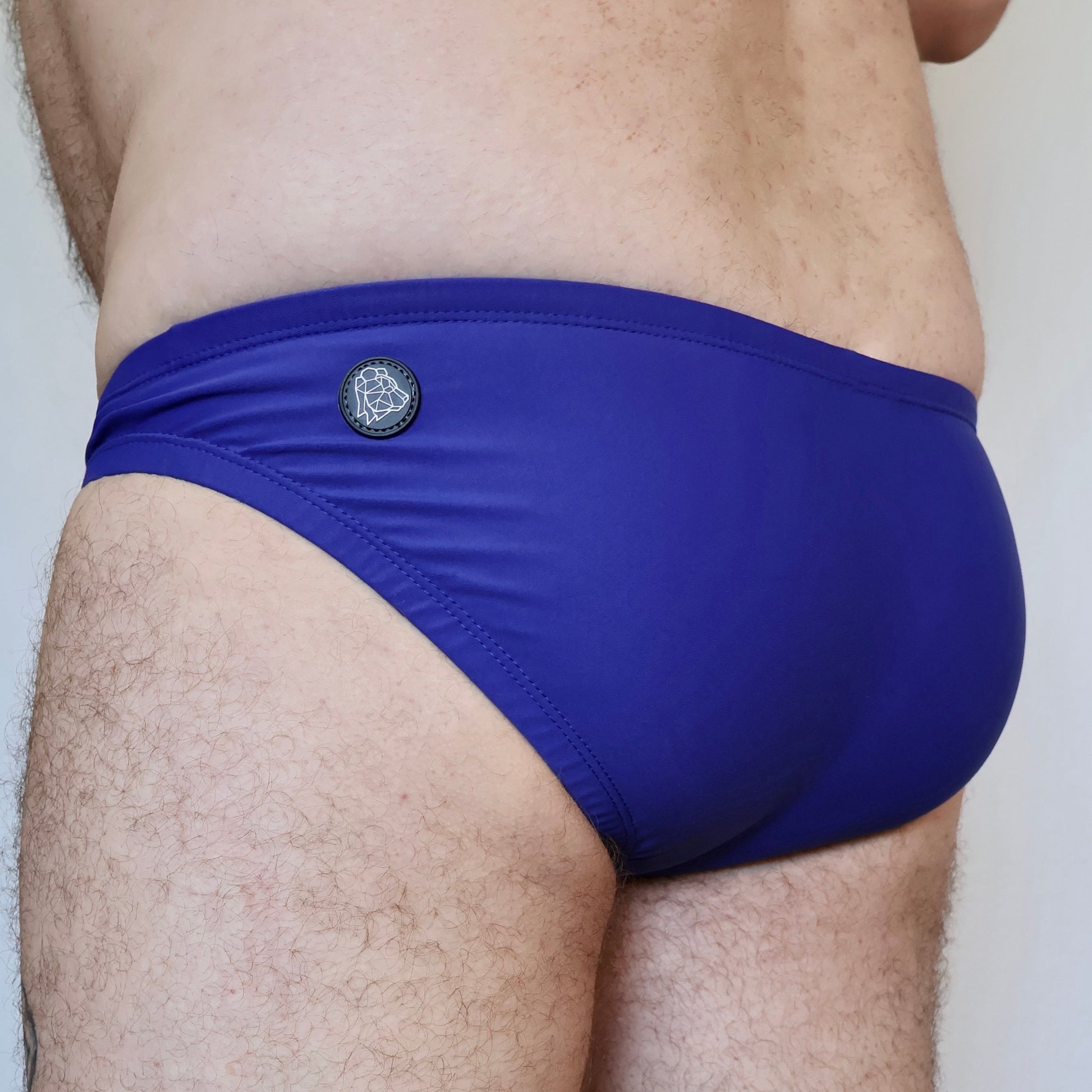 Blue men's underwear with a brand logo on a neutral background