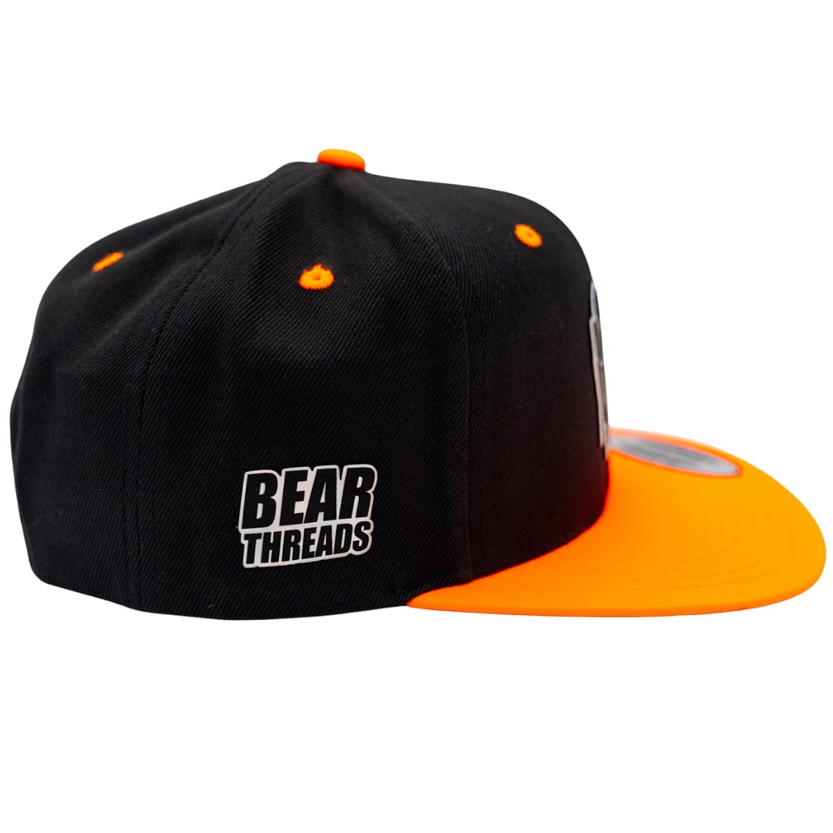 Black and orange cap with 'Bear Threads' logo on a white background